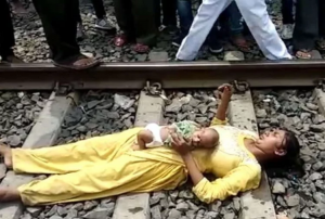 woman lying on railway track